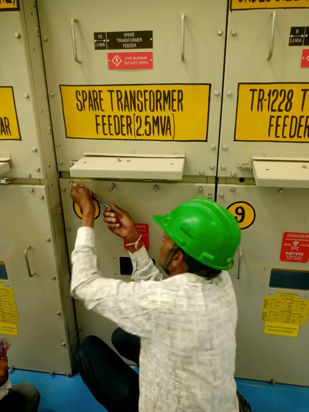 Electrical worker at industrial switchgear